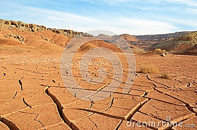 The landscape of dry mountains and mud cracked pattern on desert ground Stock Photo