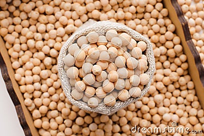 Dry organic uncooked chickpeas in wooden box and sack, top view Stock Photo