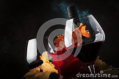 Dry Red Wine in big wine glass, autumn still life with leaves, wine tasting concept, rustic style, selective focus Stock Photo