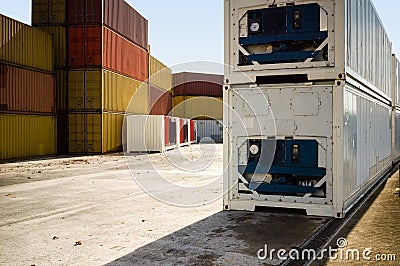 Dry and refrigerated containers stacked in a port terminal Stock Photo