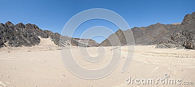 Dry river valley in desert mountains Stock Photo