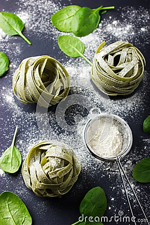 Dry spinach pasta, fresh spinach and flour Stock Photo