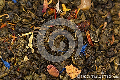 Dry tea with fruit and flower petals as background. Dried tea background. Tea texture Stock Photo