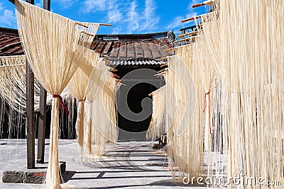 Dry thin noodles hanging in front the house Stock Photo