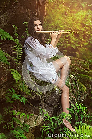 Dryad playing flute after the rain Stock Photo
