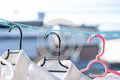 Drying clothes in the sun using a laundry rope that keeps clothes separated in windy conditions Stock Photo