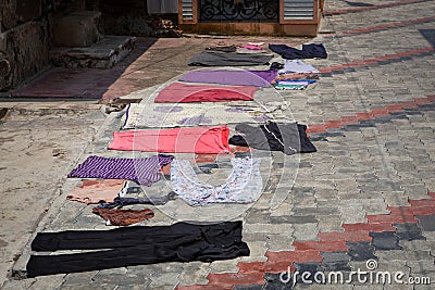 Drying clothes on a tiled surface in a city in India Stock Photo