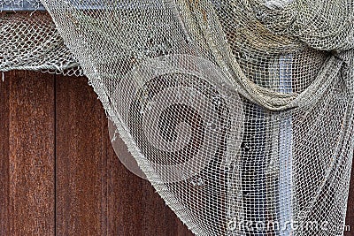 Drying old holey fishing net. Maritime nautical background texture. Stock Photo