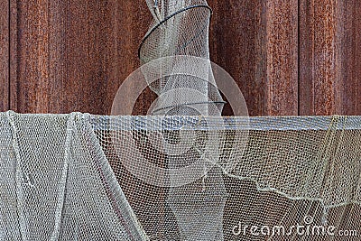 Drying old holey fishing net. Maritime nautical background texture. Stock Photo