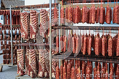 Drying saussages and bacons in the traditional method by natural air drying method Stock Photo