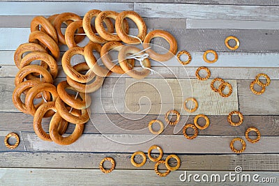 Drying wheat flour close up. Frame of big and small bagels on wooden shabby table. Russian food Stock Photo