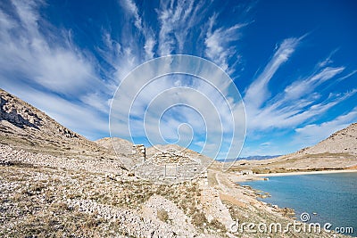 Drystone house blending into the rocky landscape of Vela Luka bay Stock Photo