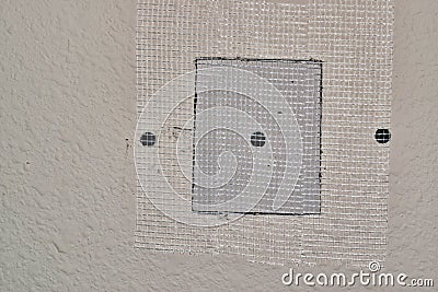 Drywall repairs in wall with fiberglass tape. Stock Photo