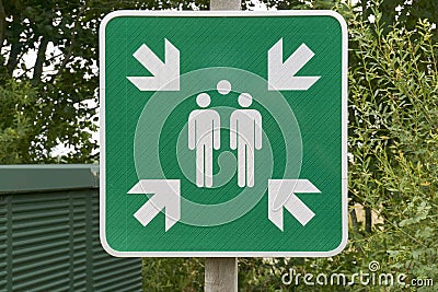 Evacuation assembly point sign in green and white Stock Photo