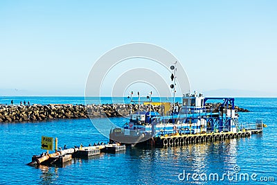 DSC dredge Twin Lakes is dredging sand and silt in harbor channel of Santa Cruz Small Craft Harbor Editorial Stock Photo