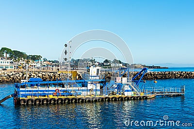 DSC dredge Twin Lakes is dredging sand and silt in harbor channel of Santa Cruz Small Craft Harbor Editorial Stock Photo