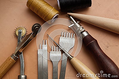 Leather Crafting Tools on the Genuine Leather on the Table, Handicraftsman Equipment for DIY Leather Works Stock Photo