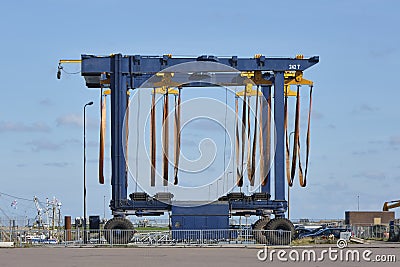 Large empty mobile boat travel lift in a harbour under a blue sky Stock Photo