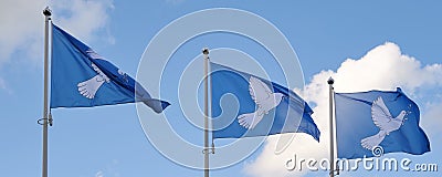 Three blue peace flags with a dove and olive branch in its beak Editorial Stock Photo