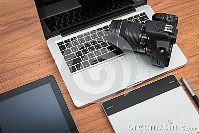 DSLR digital camera with tablet and notebook laptop Stock Photo