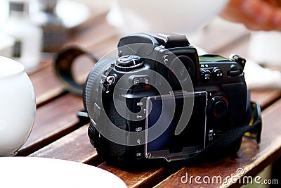 DSLR photo camera standing on table Stock Photo