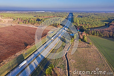 A road on a vast plain covered with forests. Stock Photo