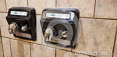 Dual double black electric industrial hand dryers for community bathroom Editorial Stock Photo