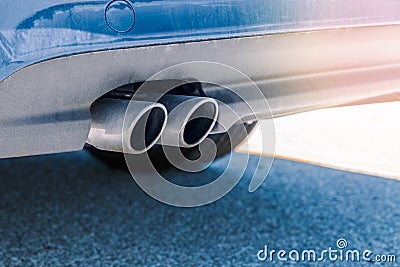 dual double exhaust pipe. Detail of stylish blue car exterior. Stock Photo