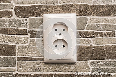 Dual power socket connecting electrical appliances at home energy on the wall Stock Photo