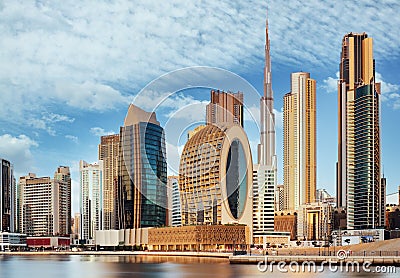 Dubai Downtown skyline landscape with reflections in Dubai Creek at sunrise, from Dubai Creek Harbour promenade. UAR Stock Photo