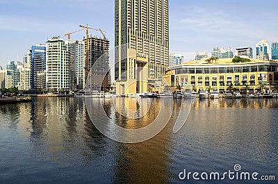 Dubai Marina Mall is an indoor shopping mall in Dubai with yachts parking and waterfront. Editorial Stock Photo
