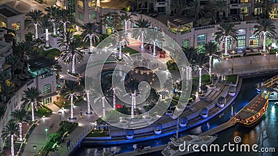 Dubai Marina Walk with fountain and palms aerial Top View night timelapse Editorial Stock Photo