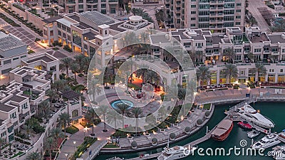 Dubai Marina Walk with fountain and palms aerial Top View night to day timelapse Editorial Stock Photo