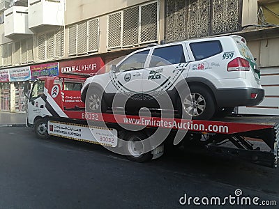 Dubai police car on top of towing truck Editorial Stock Photo