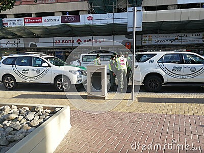 Dubai police men standing together and discussing Editorial Stock Photo