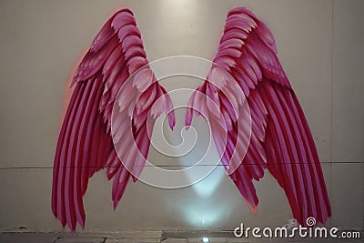 Dubai UAE December 2019 Pink Wings on wall. Large Human sized pink angel wings painted. Painted walls, graffiti art, and Editorial Stock Photo