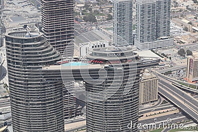 Boat shaped building top with a big swimming pool and recreational area provides best views of the downtown Dubai at Sky view Emaa Editorial Stock Photo