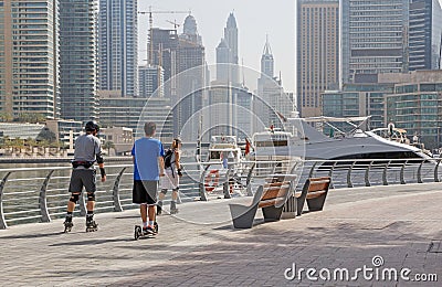 DUBAI, UAE - MAY 12, 2016: roller skaters on pedestrian walkway Editorial Stock Photo