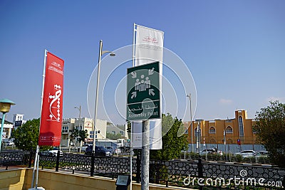 Dubai UAE - November 2019: Emergency assembly point information sign in white paint on green background fixed to a pole to direct Editorial Stock Photo