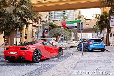 Dubai, UAE - November 20, 2013. A red Ferrari driving in Dubai Maria district Editorial Stock Photo