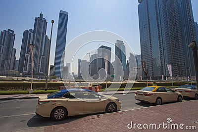 two taxi cars waiting for passengers in the street. Dubai city Editorial Stock Photo