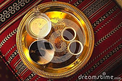 Dubai, UAE - 12th october, 2022: Top view coffee set up on silver plate of two cups and dates in bowl in coffee museum in Dubai Editorial Stock Photo