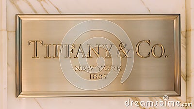 Dubai, UAE, United Arab Emirates - May 28, 2021: Close golden logotype Tiffany Co is an American luxury jewelry and Editorial Stock Photo