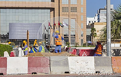 Dubai, UAE - 10.04.2021 Workers upgrading road infrastructure. Industrial Editorial Stock Photo