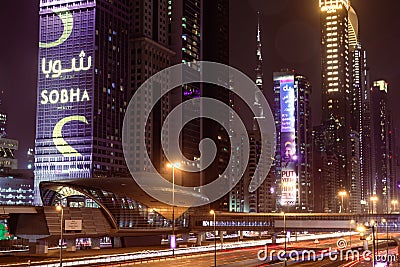 Dubai, United Arab Emirates; Emirates Towers metro station at night; night time traffic; motion blur, long exposure Editorial Stock Photo