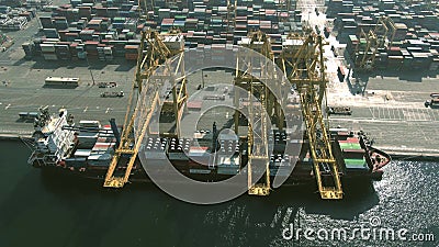 DUBAI, UNITED ARAB EMIRATES - DECEMBER 29, 2019. Aerial view of a docked container ship being loaded and unloaded at Editorial Stock Photo