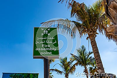 Dubai, United Arab Emirates - December 12, 2018: Fire Assembly Point Sign in Arabic and English Editorial Stock Photo
