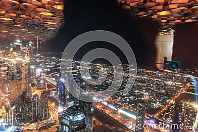 Dubai, United Arab Emirates â€“ December 14, 2021, the people visiting the the 24th and 25th floor of Burj Khalifa at night and Editorial Stock Photo