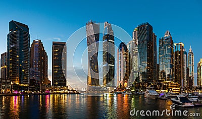 Dubai, United Arab Emirates - February 14, 2019: Dubai marina modern skyscrapers and luxury yachts at blue hour Editorial Stock Photo