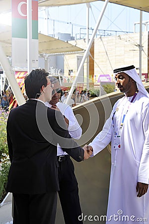 DUBAI, UNITED ARAB EMIRATES, UAE - JUNE 20, 2019: An Arab man and a western man shake hands as a sign of peace. the concept of Editorial Stock Photo